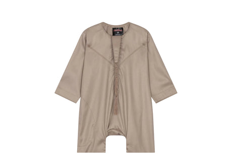 A beige baby romper thobe with traditional Emirati embroidery and a removable tassel.